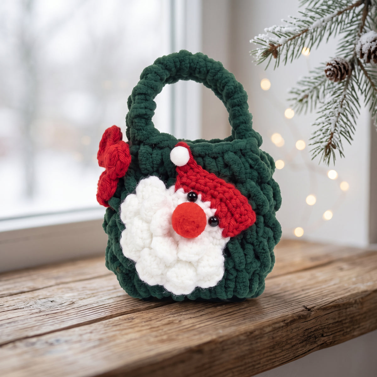 Handmade green crochet Santa gnome mini tote bag placed on wooden windowsill, winter Christmas decor with pine and warm fairy lights