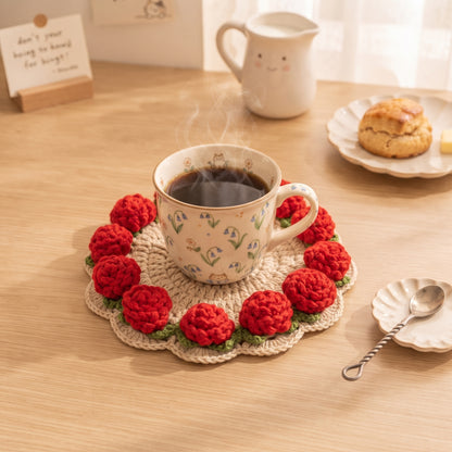 Red rose crochet coaster under cute cat-patterned mug of hot coffee, scone on plate and smiling milk jug, cozy breakfast table setting, handmade home decor