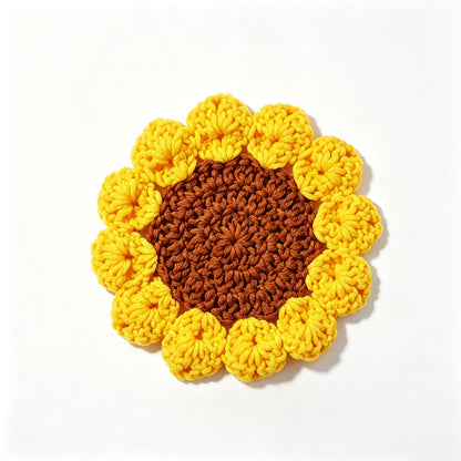 Yellow handmade crochet sunflower coaster with brown textured center and 3D petals, flat lay on plain white background, cute floral drink mat