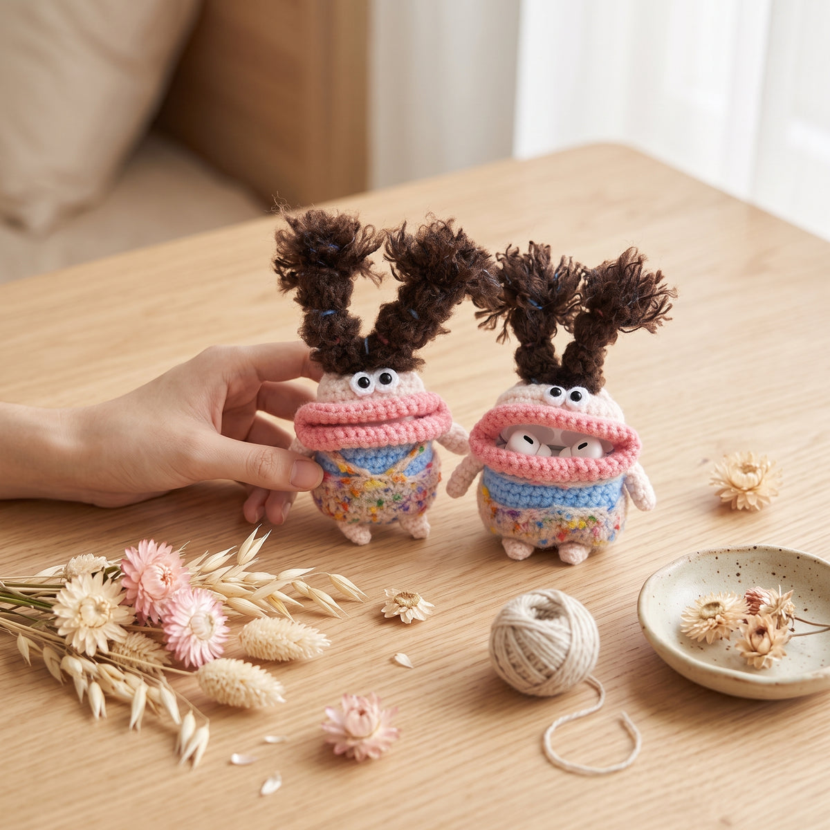 Funny monster crochet AirPods cover displaying a playful handmade design for everyday earbuds