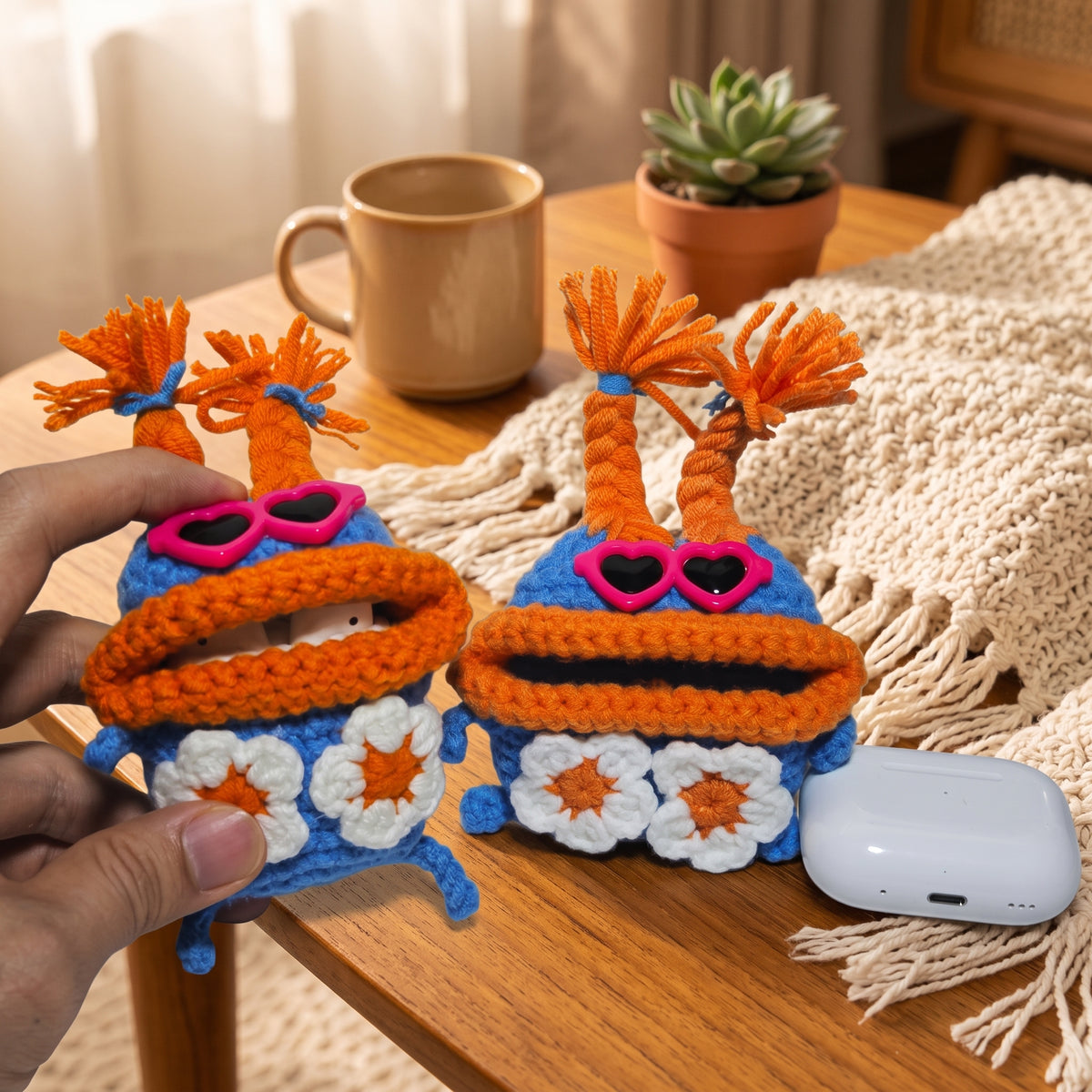 Quirky monster crochet charging case with braided orange hair.